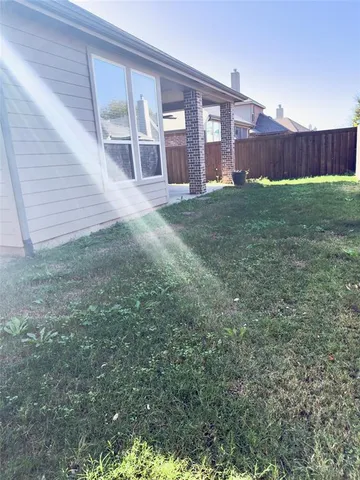 a view of a backyard of the house