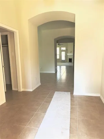 a large kitchen with granite countertop a large counter top and stainless steel appliances