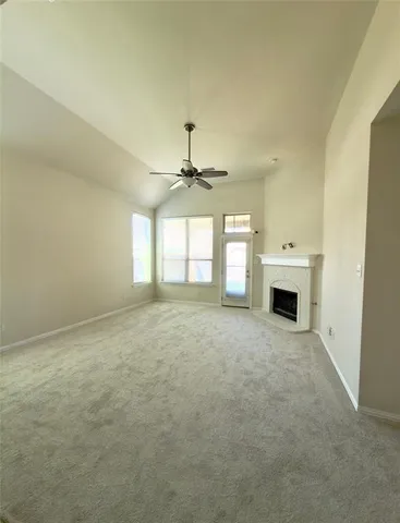 a view of a hallway with wooden floor and a living room