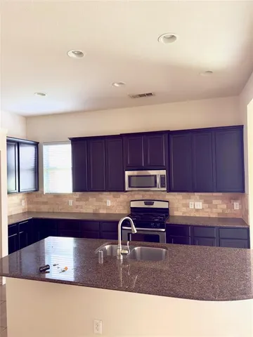 an empty room with fireplace and windows