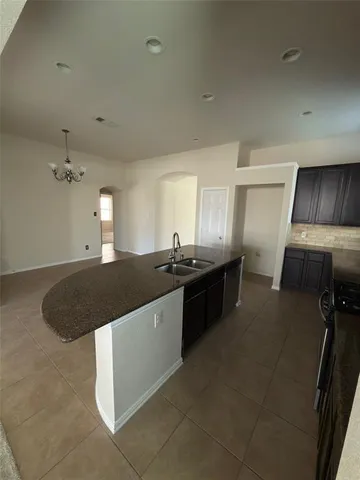 a view of a kitchen with a sink and dishwasher kitchen appliances