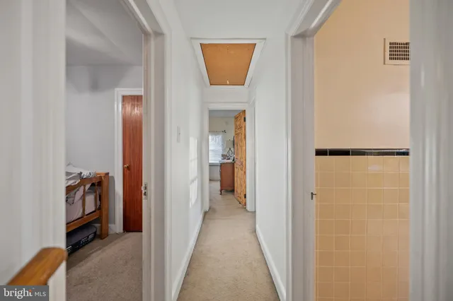 a view of a hallway with closet and a couch
