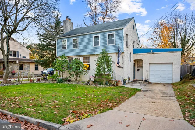 a front view of a house with a garden and yard