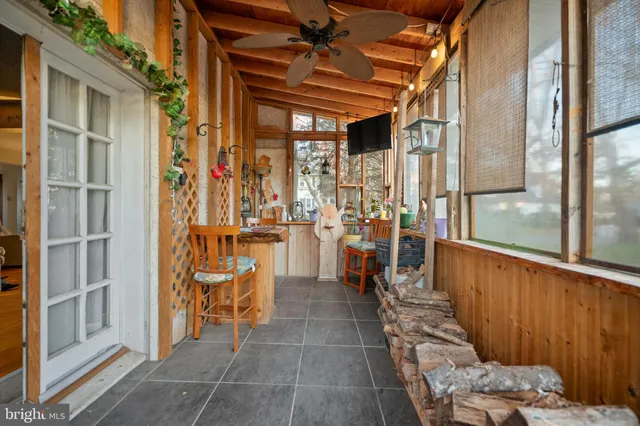 a dining room with furniture and a chandelier