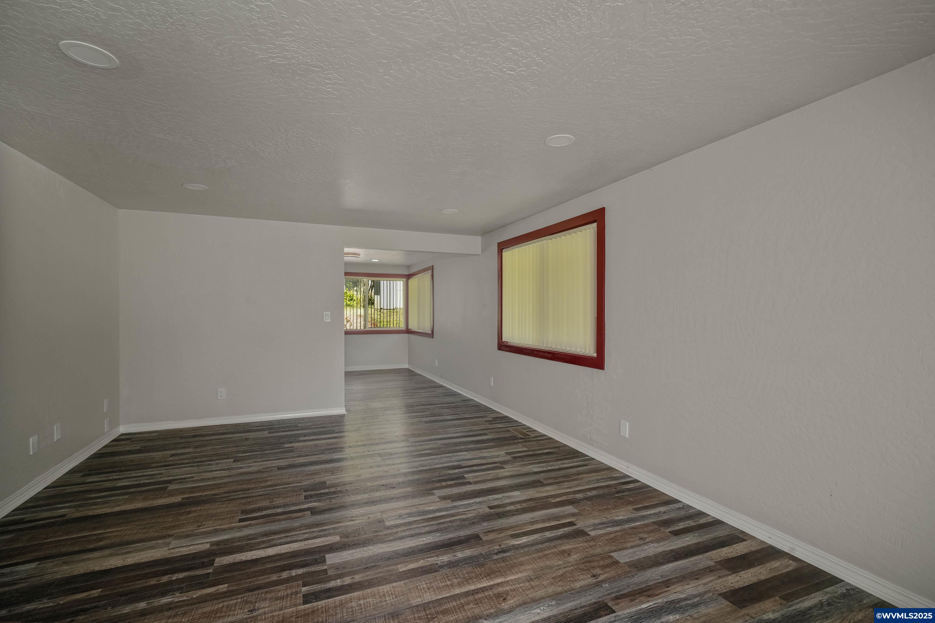 16170 McBee Road Dallas, OR 97338 - Photo 9 of 41 a view of an empty room with wooden floor and a window