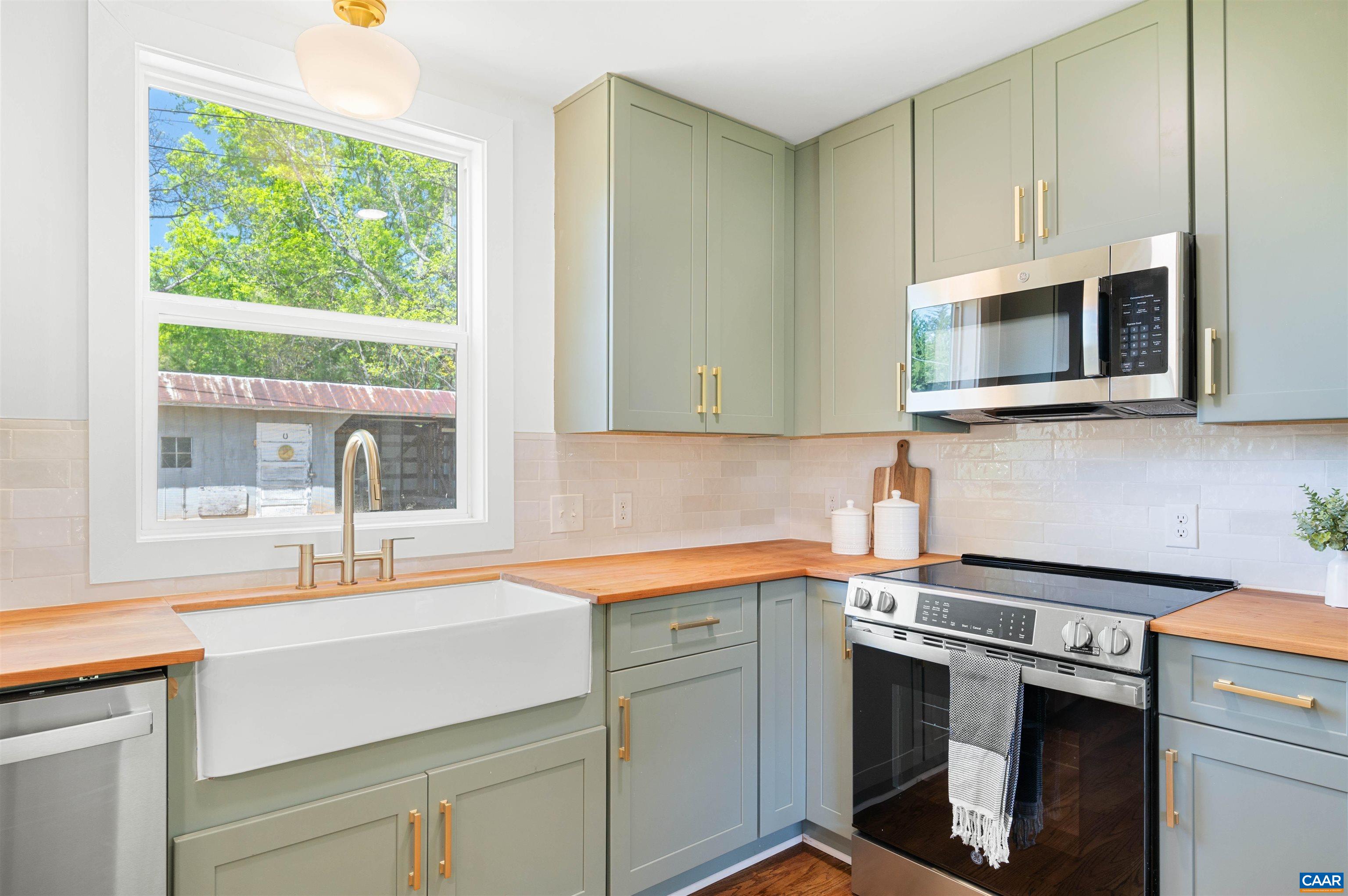 1867 Stage Junction Road Columbia, VA 23038 - Photo 22 of 46 a kitchen with stainless steel appliances granite countertop a sink a stove and a microwave