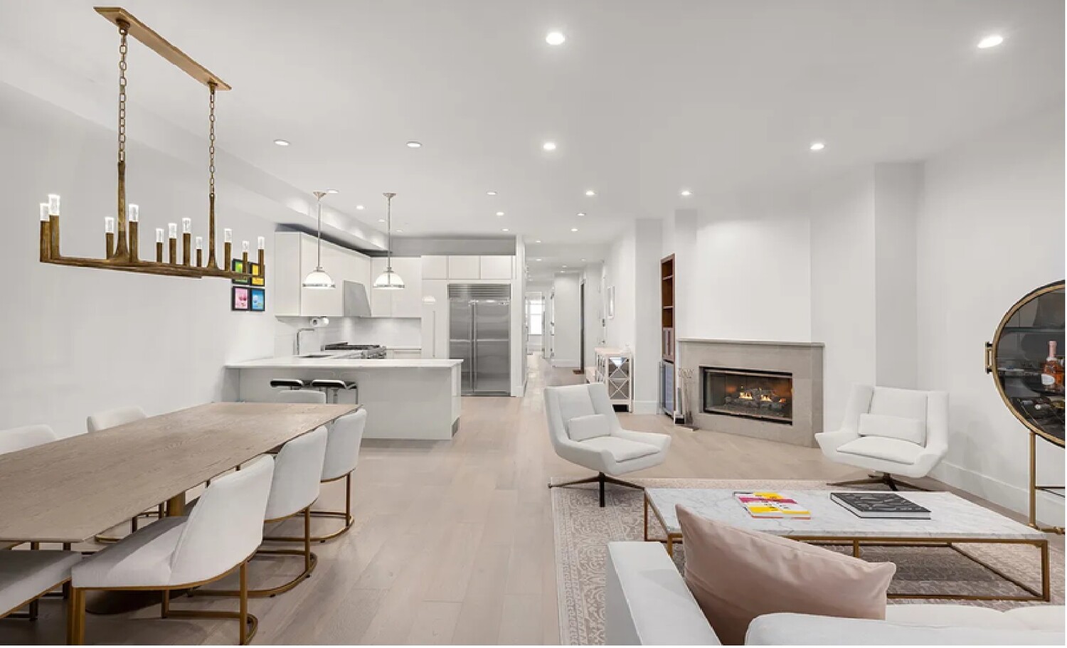 53 Murray Street, Unit 5 Manhattan, NY 10007 - Photo 3 of 11 a living room with furniture a fireplace a rug and kitchen view