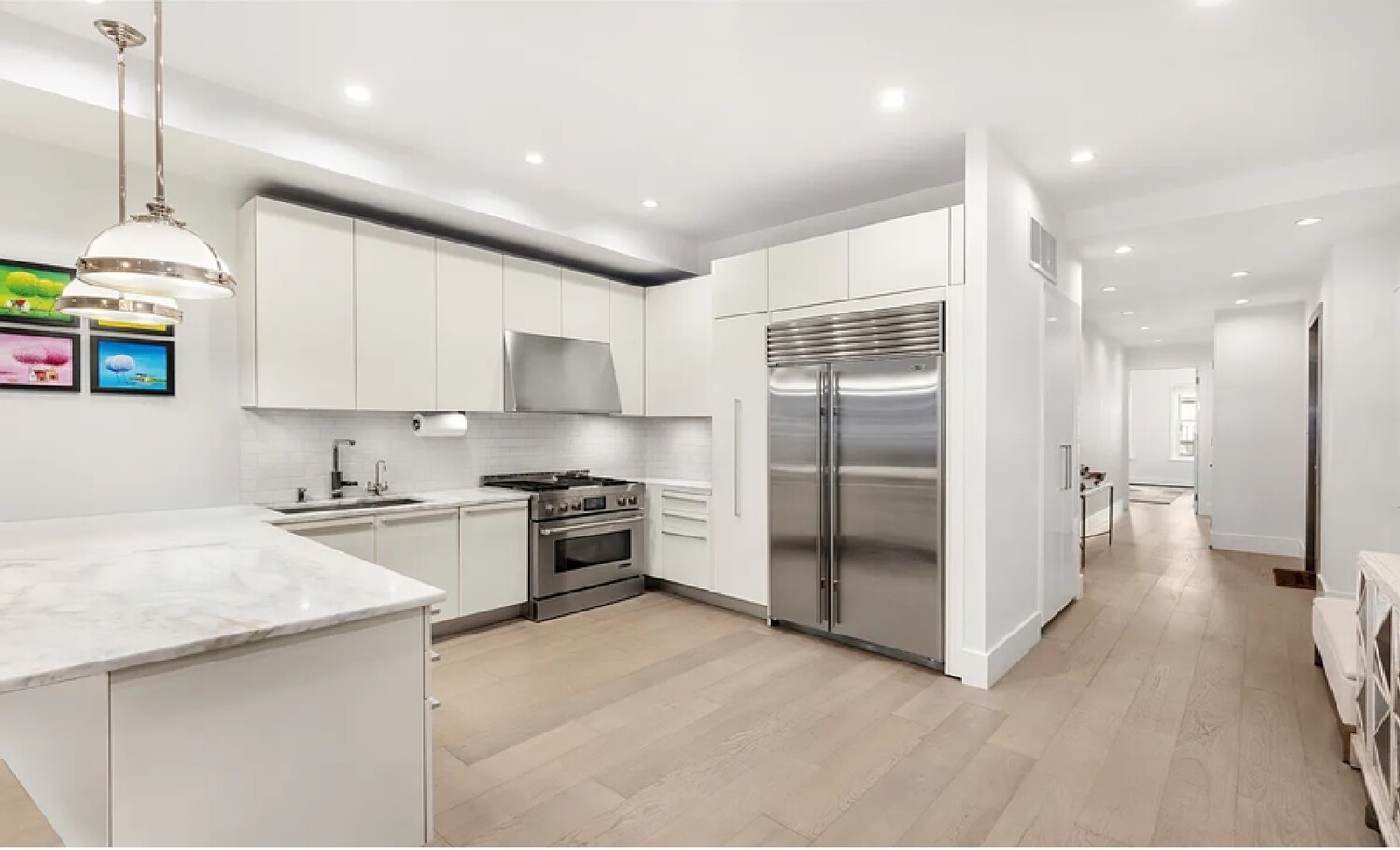 53 Murray Street, Unit 5 Manhattan, NY 10007 - Photo 4 of 11 a kitchen with stainless steel appliances granite countertop a refrigerator a stove and a sink