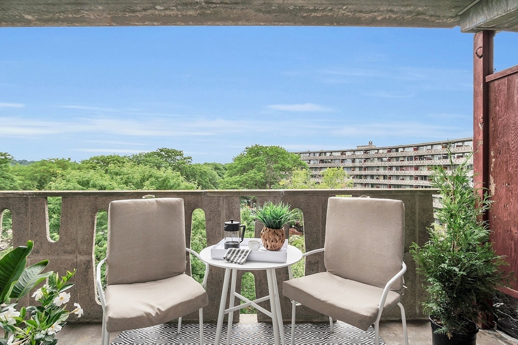 200 Swanton Street, Unit 502 Winchester, MA 01890 - Photo 17 of 24 a balcony with table and chairs