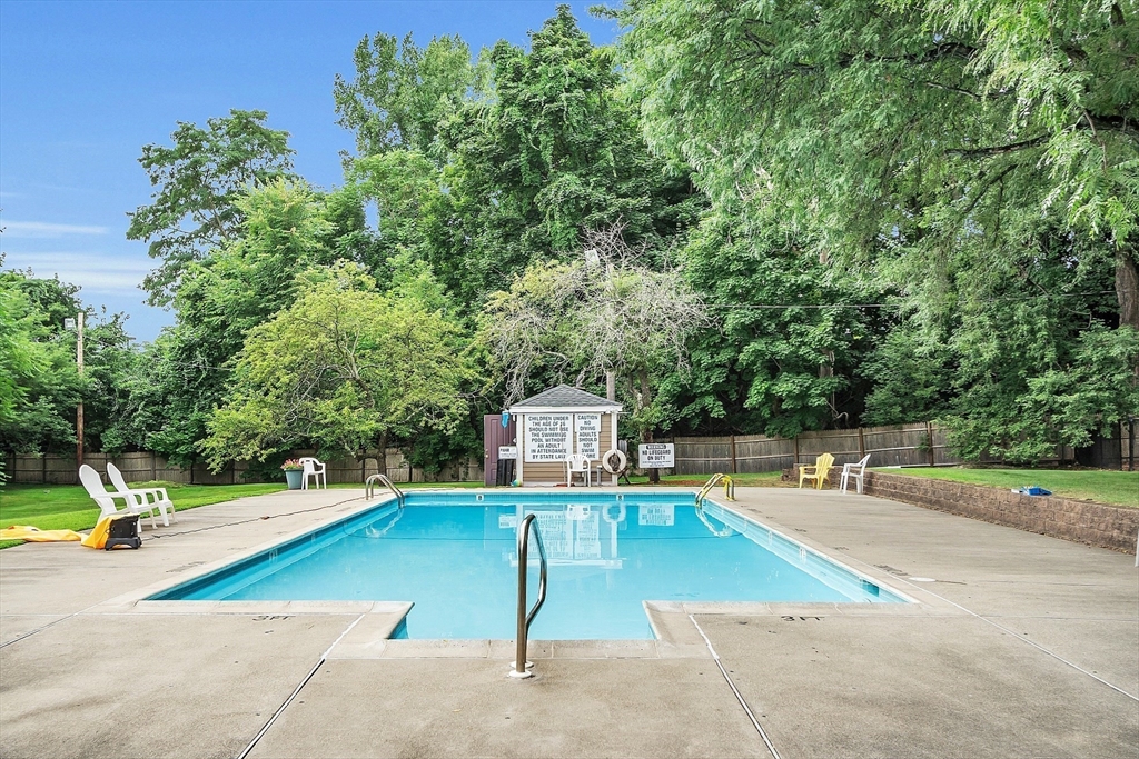 200 Swanton Street, Unit 502 Winchester, MA 01890 - Photo 18 of 24 a view of a swimming pool with a lounge chair