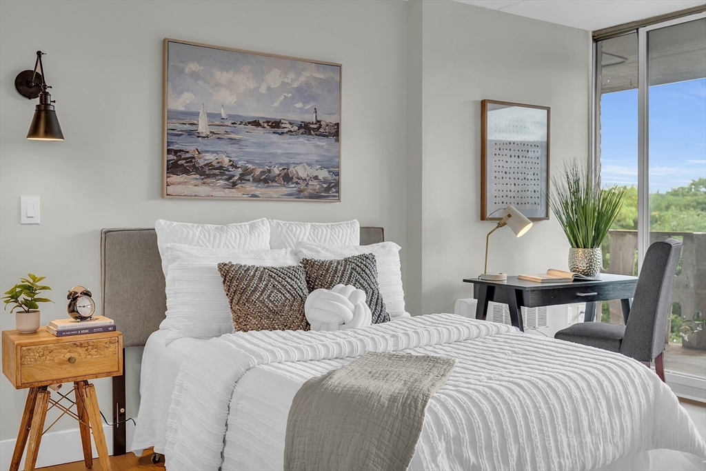 200 Swanton Street, Unit 502 Winchester, MA 01890 - Photo 2 of 24 a bedroom with a bed and wooden floor