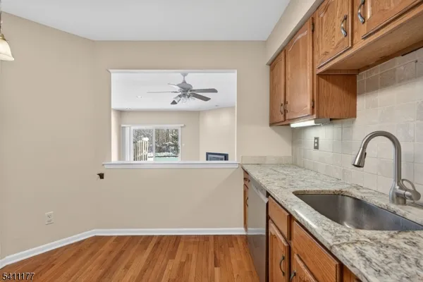 a kitchen with a sink cabinets and a wooden floor