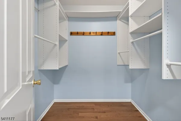 a view of walk in closet with clothes