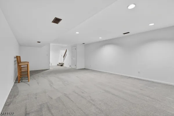 an empty room with staircase and white walls