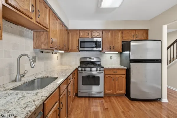 a kitchen with a sink cabinets and stainless steel appliances