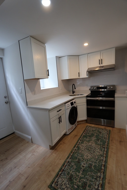 331 Proctor Avenue Revere, MA 02151 - Photo 19 of 29 a kitchen with a stove sink and a refrigerator