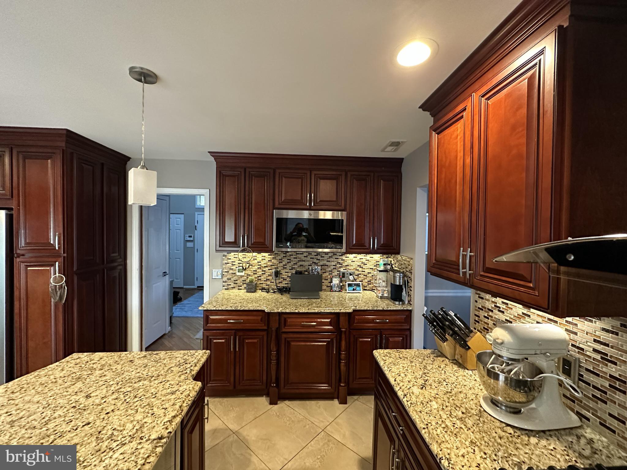 2269 Pine Road Huntingdon Valley, PA 19006 - Photo 24 of 61 a kitchen with granite countertop wooden cabinets and stainless steel appliances
