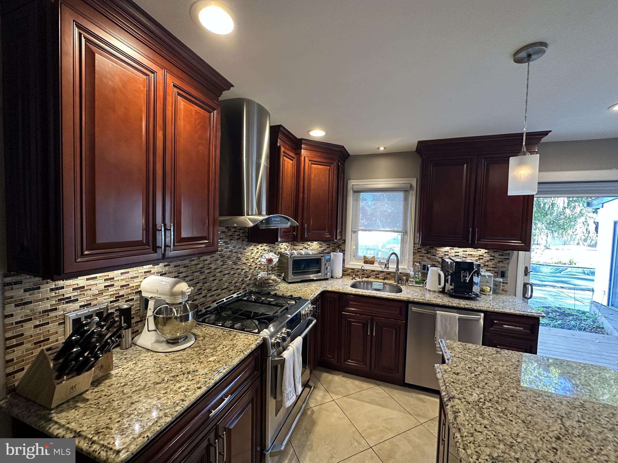 2269 Pine Road Huntingdon Valley, PA 19006 - Photo 25 of 61 a kitchen with stainless steel appliances granite countertop wooden cabinets a sink and a stove