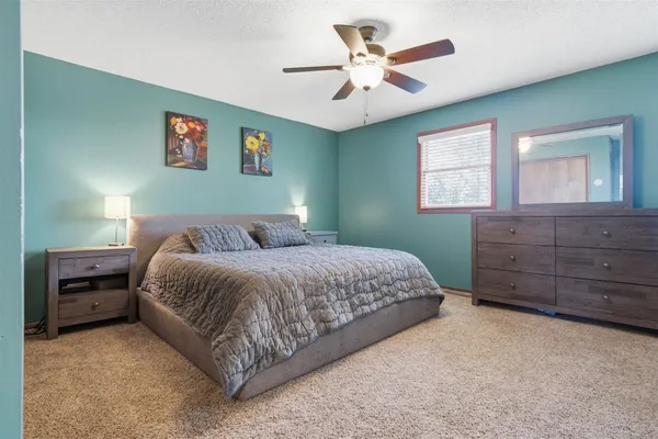 a bedroom with a large bed and a dresser