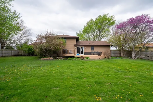 a view of a house with yard and tree s