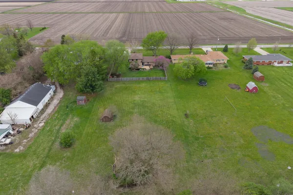 an aerial view of a house with garden space and street view