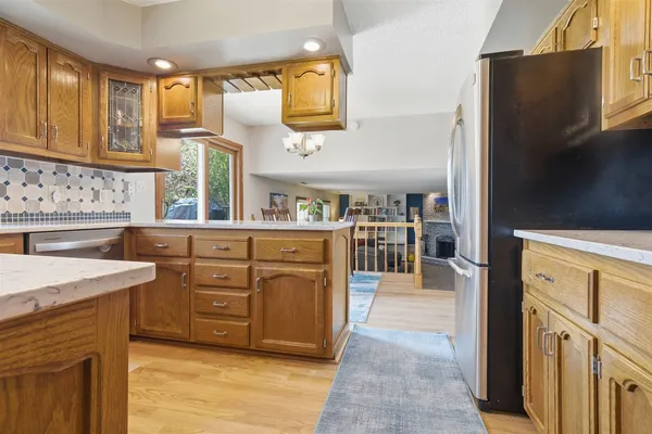 a kitchen with stainless steel appliances granite countertop a stove a sink and a microwave