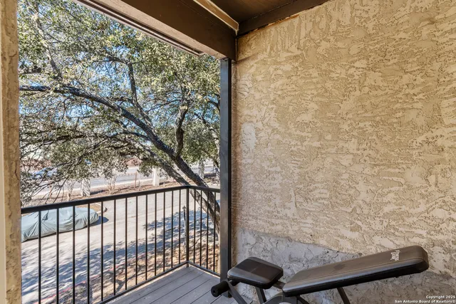 a view of a balcony with wooden floor