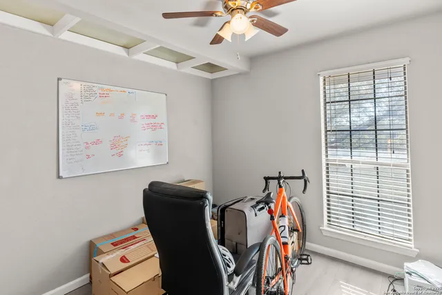 a view of a workspace with furniture and a window