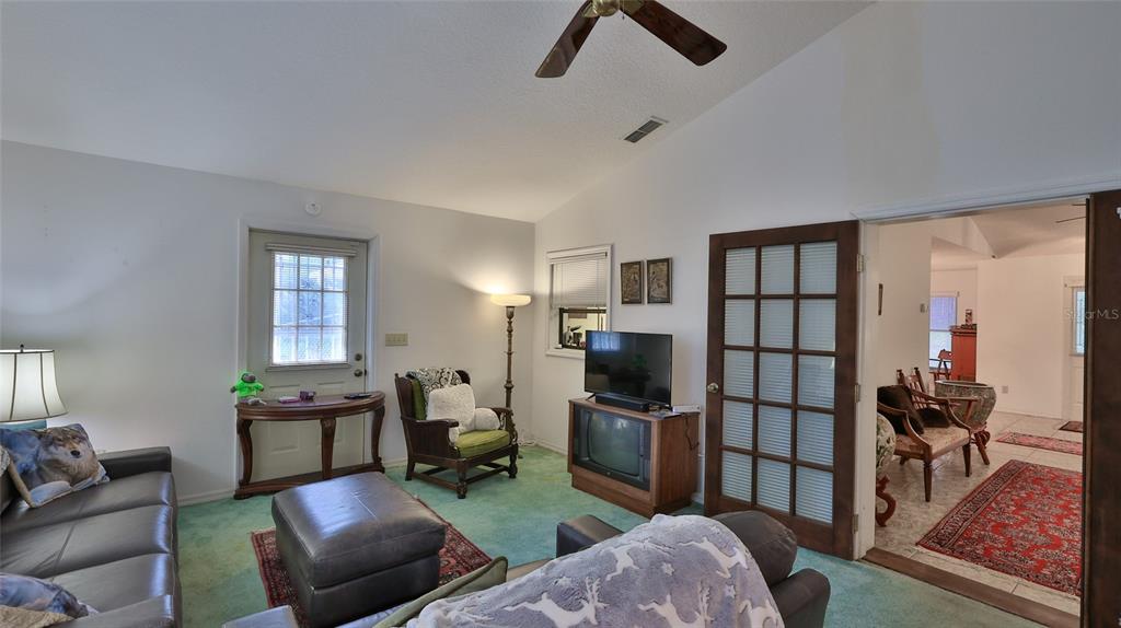 3085 Howland Boulevard Deltona, FL 32725 - Photo 13 of 14 a living room with furniture a rug and a window