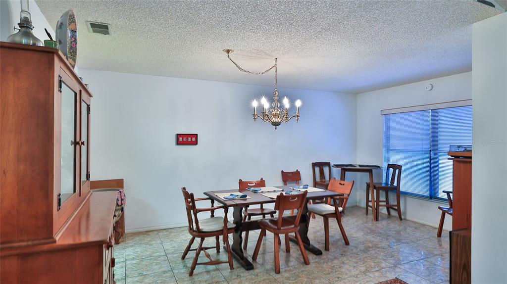 3085 Howland Boulevard Deltona, FL 32725 - Photo 8 of 14 a view of a dining room with furniture and chandelier