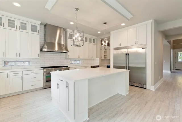 a kitchen with stainless steel appliances granite countertop a sink stove and cabinets