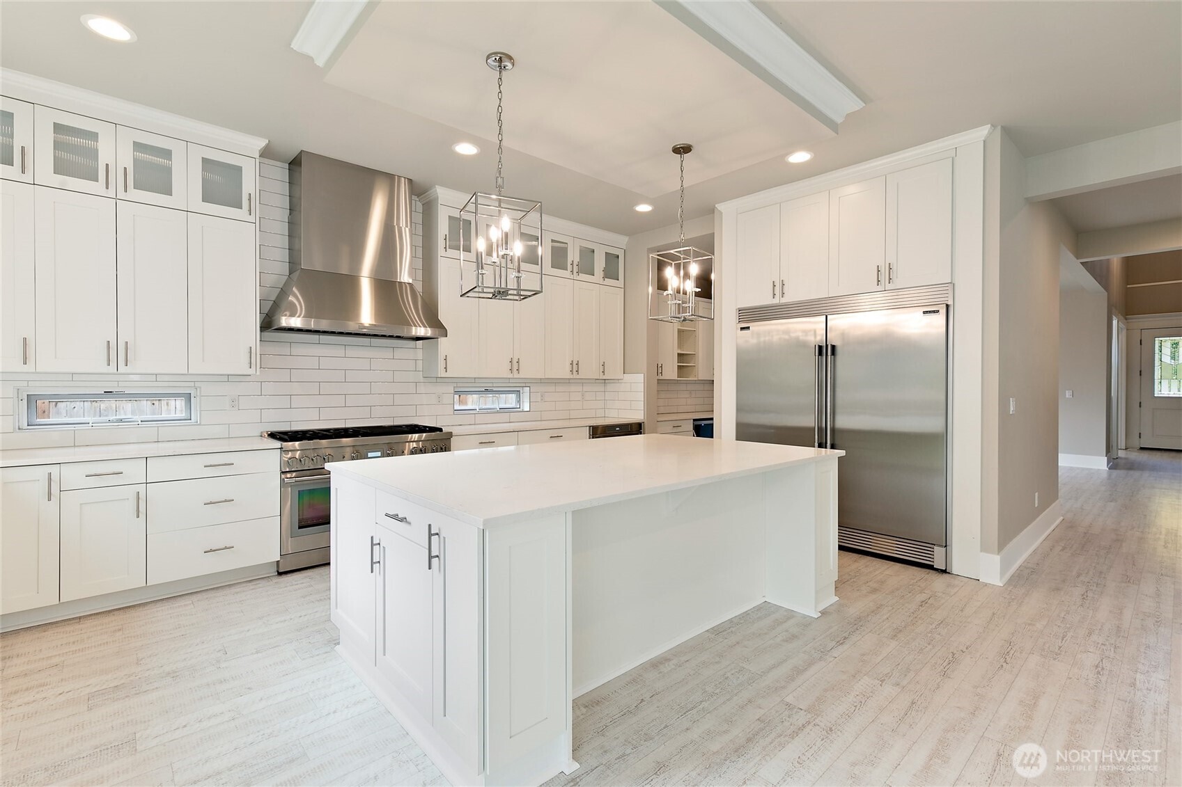 11575 Southeast 81st Street Newcastle, WA 98056 - Photo 13 of 40 a kitchen with white cabinets and stainless steel appliances