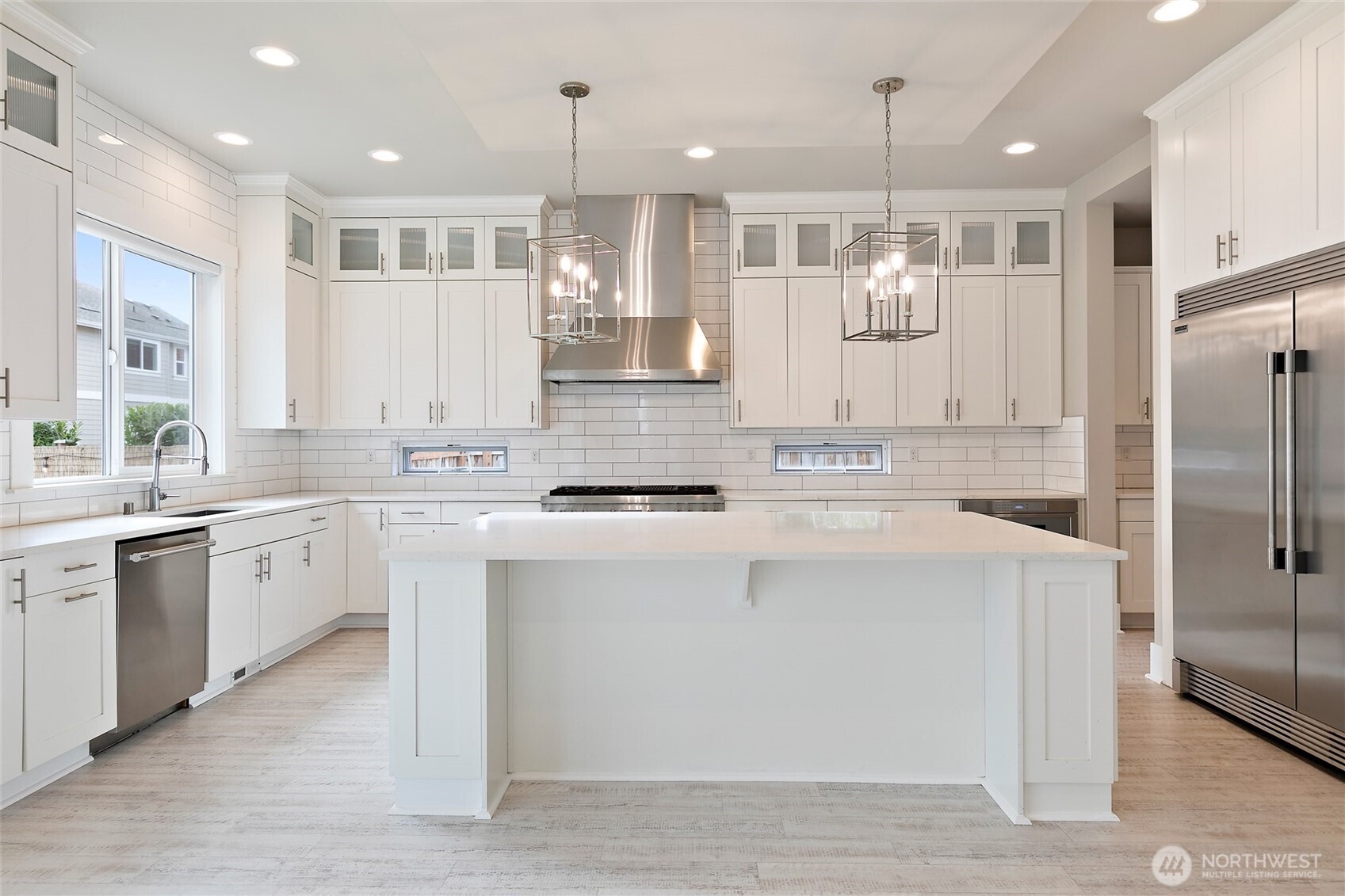 11575 Southeast 81st Street Newcastle, WA 98056 - Photo 15 of 40 a kitchen with kitchen island granite countertop a sink cabinets and stainless steel appliances