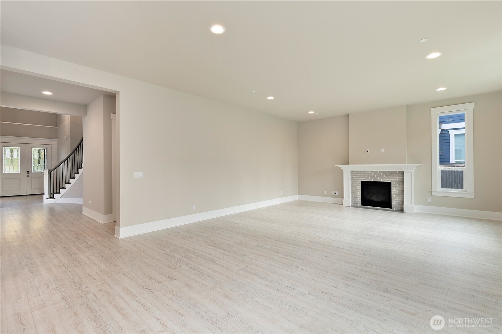 11575 Southeast 81st Street Newcastle, WA 98056 - Photo 17 of 40 an empty room with wooden floor and fireplace