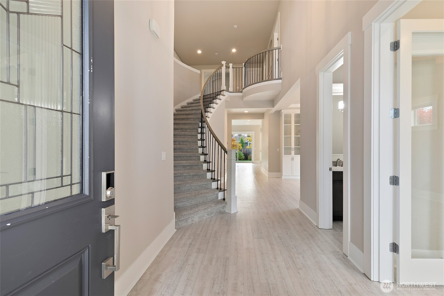11575 Southeast 81st Street Newcastle, WA 98056 - Photo 2 of 40 a view of a hallway with wooden floor and staircase
