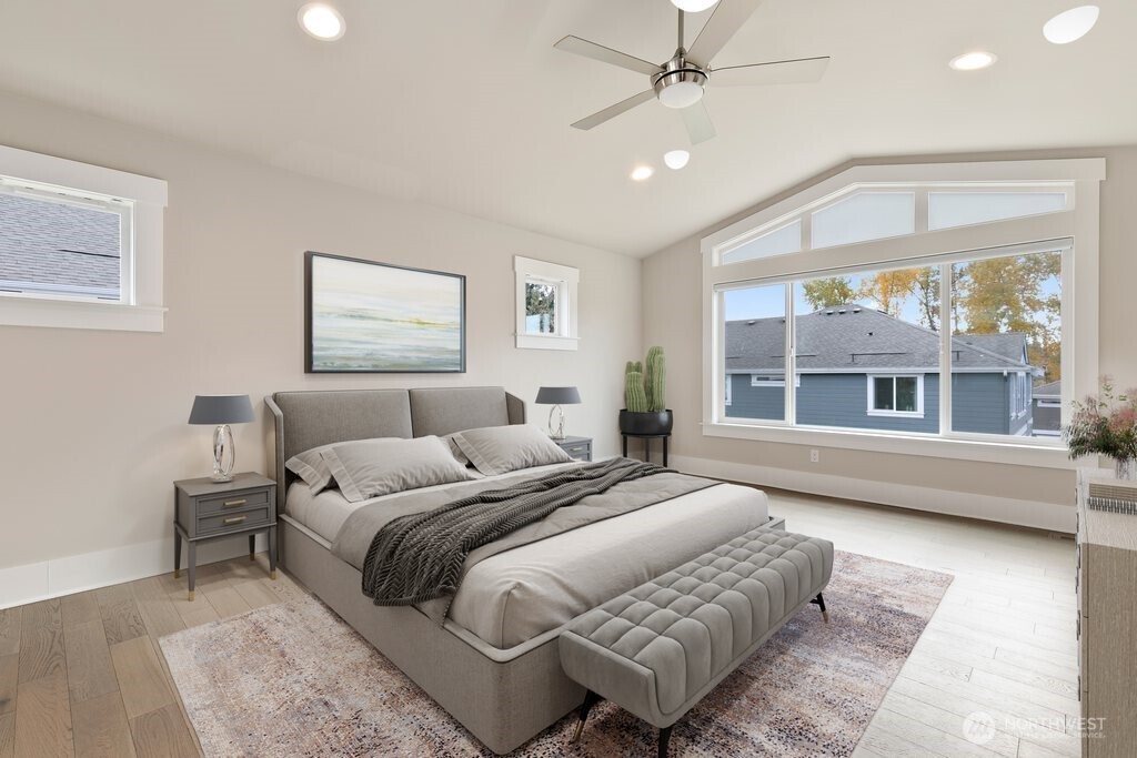 11575 Southeast 81st Street Newcastle, WA 98056 - Photo 25 of 40 a spacious bedroom with a large bed and a chandelier