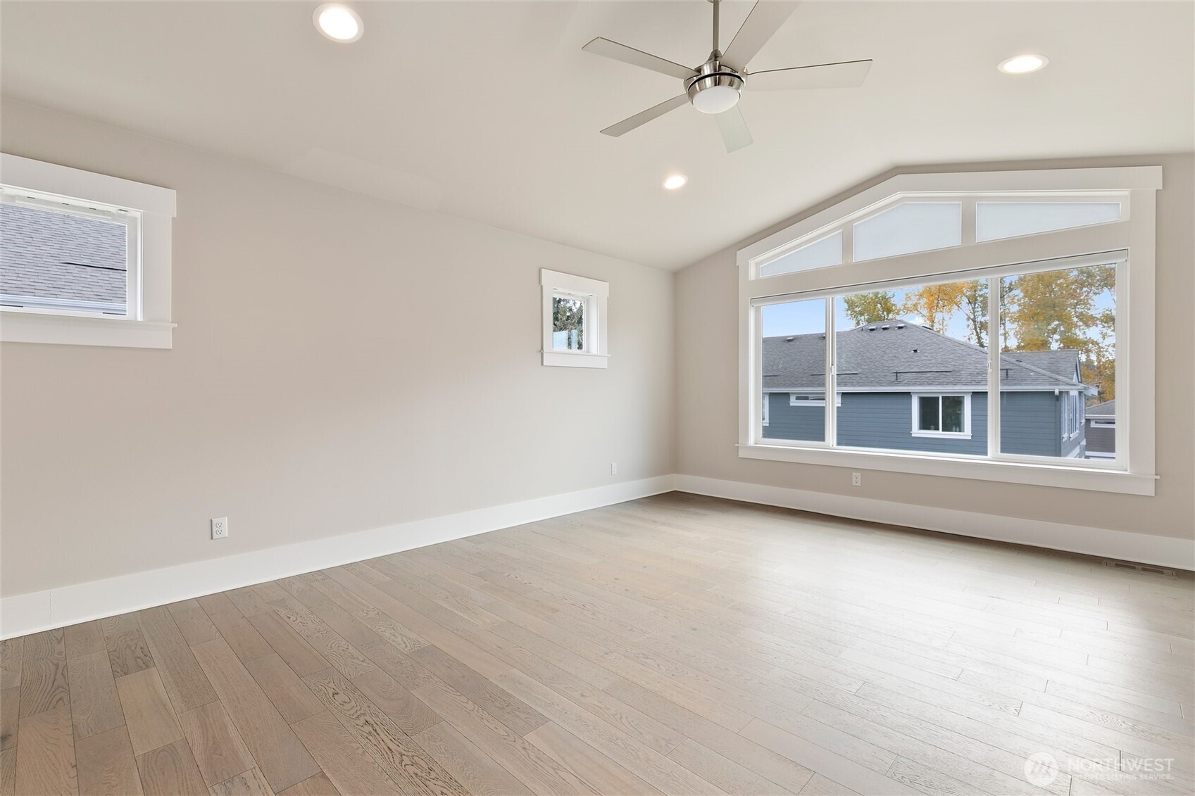 11575 Southeast 81st Street Newcastle, WA 98056 - Photo 26 of 40 an empty room with wooden floor fan and windows