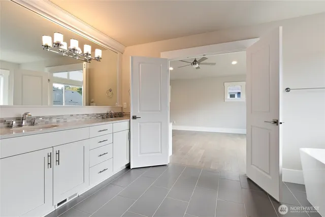 a bathroom with a sink a mirror and a bathtub