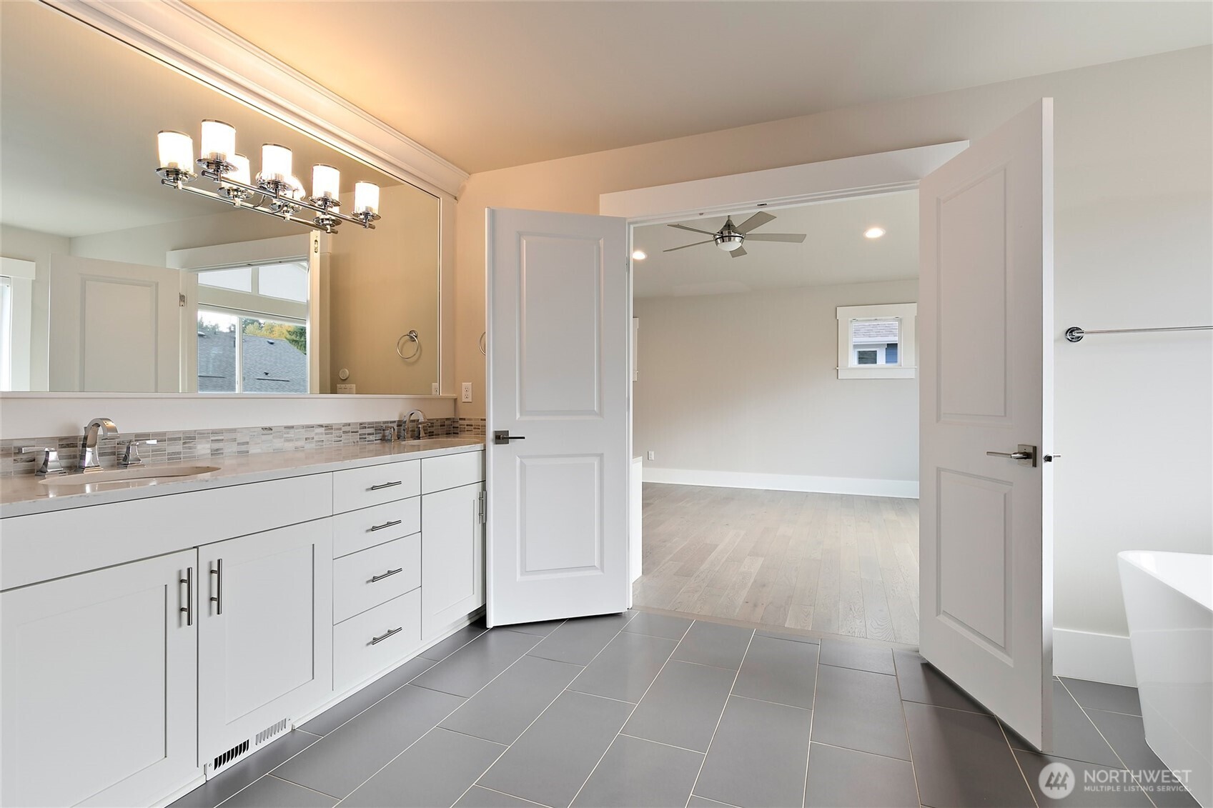 11575 Southeast 81st Street Newcastle, WA 98056 - Photo 28 of 40 a bathroom with a granite countertop sink mirror and a shower