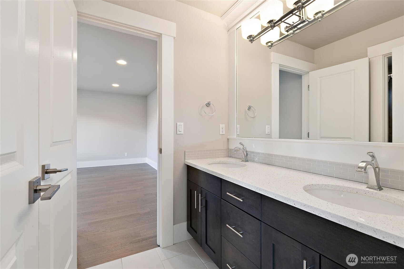 11575 Southeast 81st Street Newcastle, WA 98056 - Photo 32 of 40 a bathroom with a double vanity sink a mirror and shower