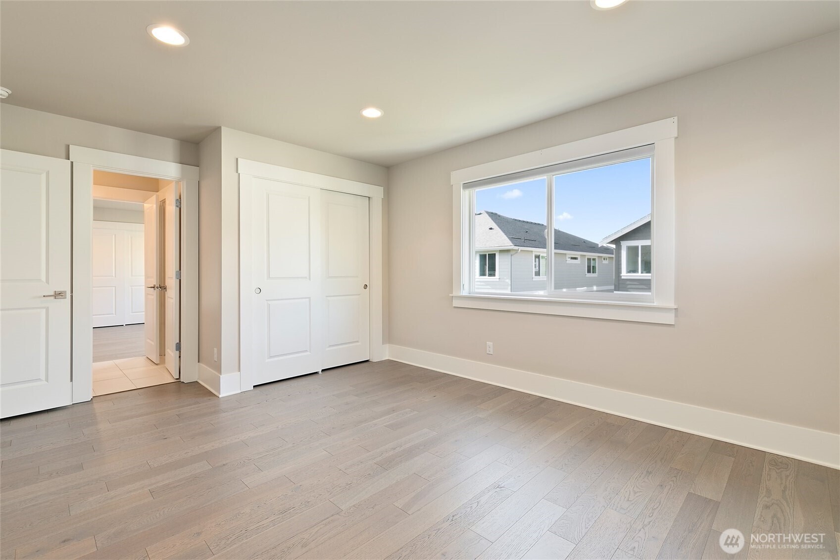 11575 Southeast 81st Street Newcastle, WA 98056 - Photo 33 of 40 an empty room with wooden floor and windows