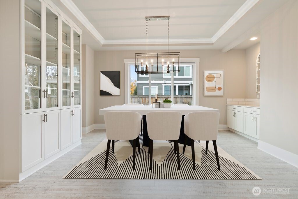 11575 Southeast 81st Street Newcastle, WA 98056 - Photo 5 of 40 a dining room with furniture a rug and a chandelier