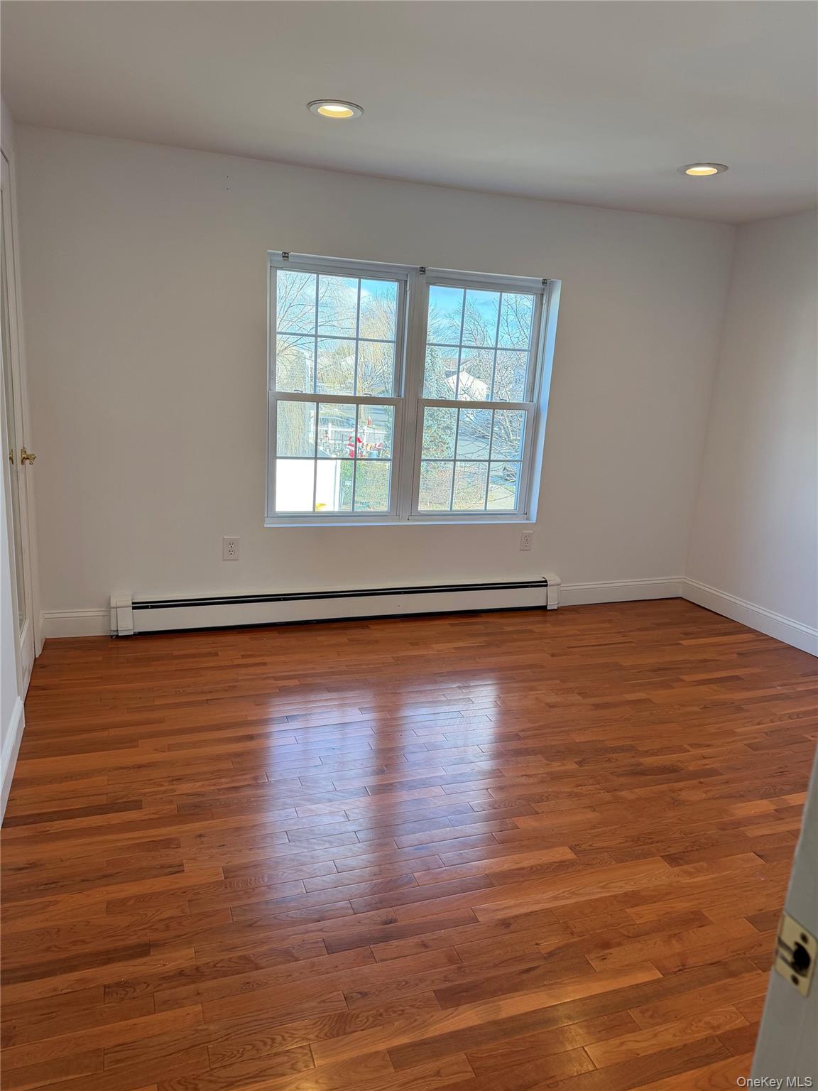 72 North Fordham Road Hicksville, NY 11801 - Photo 13 of 27 wooden floor in an empty room with a window