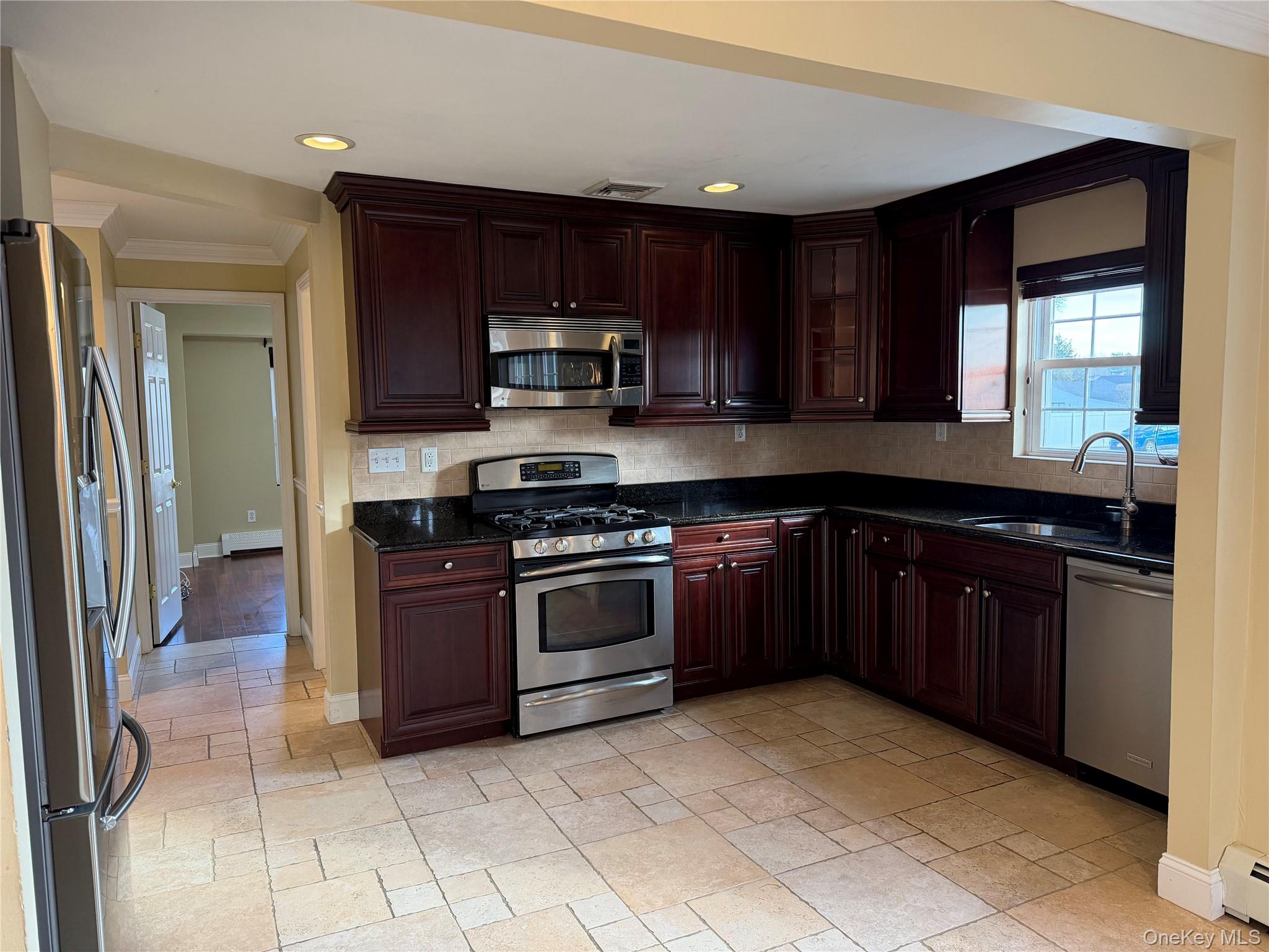 72 North Fordham Road Hicksville, NY 11801 - Photo 5 of 27 a kitchen with stainless steel appliances granite countertop a stove a sink and a refrigerator
