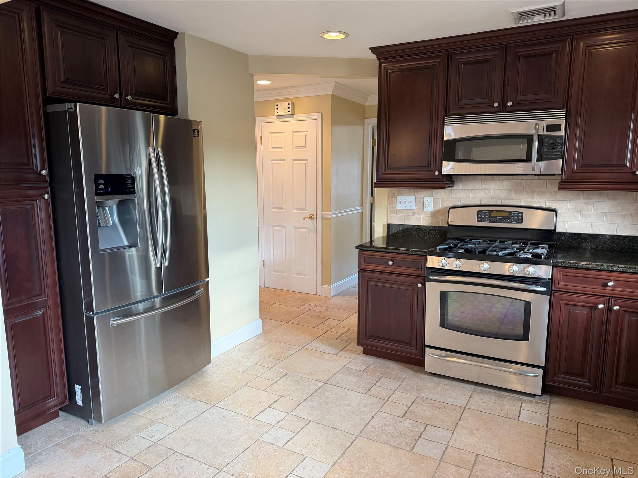72 North Fordham Road Hicksville, NY 11801 - Photo 6 of 27 a kitchen with granite countertop a refrigerator and a stove top oven