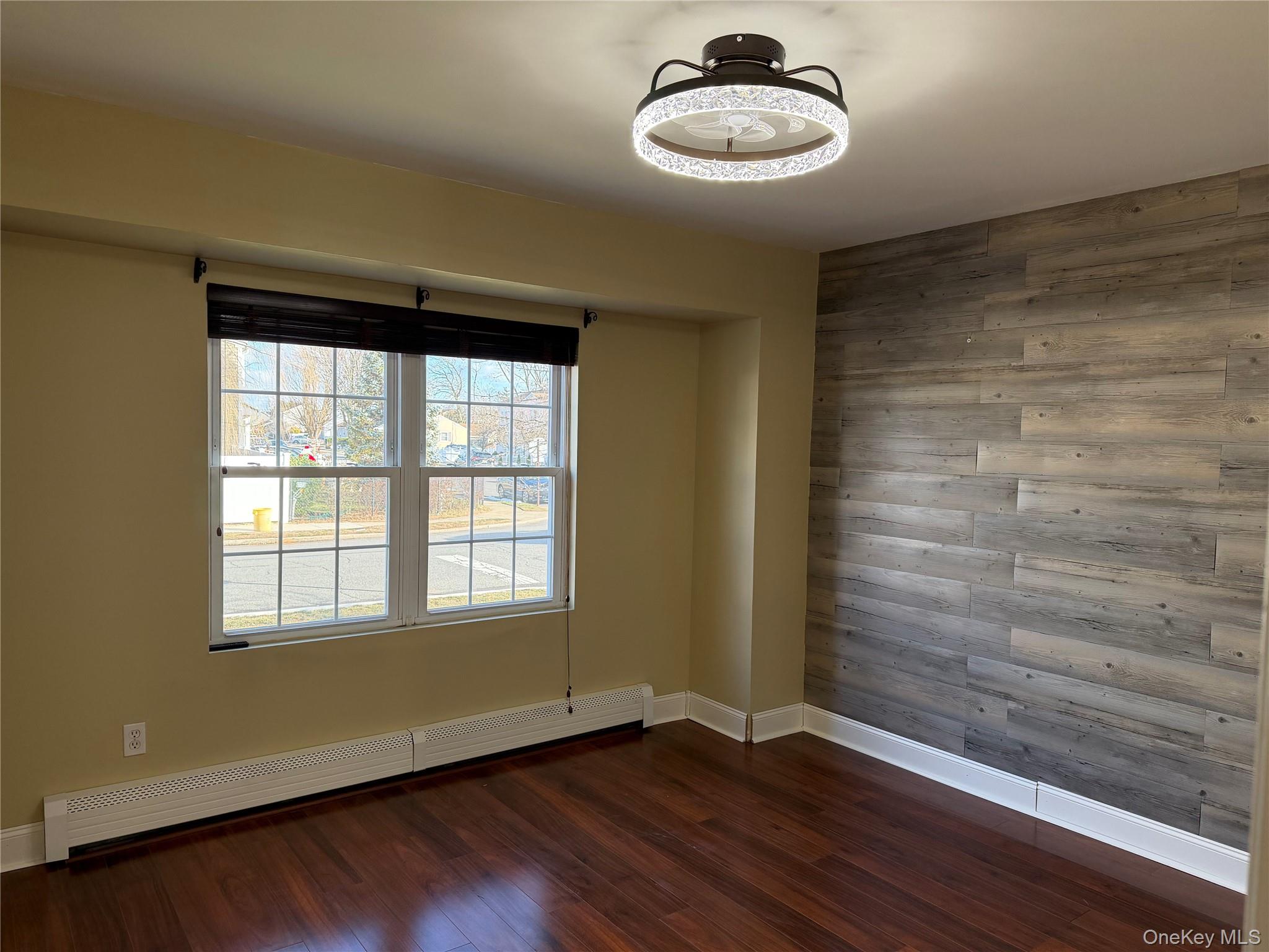 72 North Fordham Road Hicksville, NY 11801 - Photo 7 of 27 a view of a room with a wooden floor and a window
