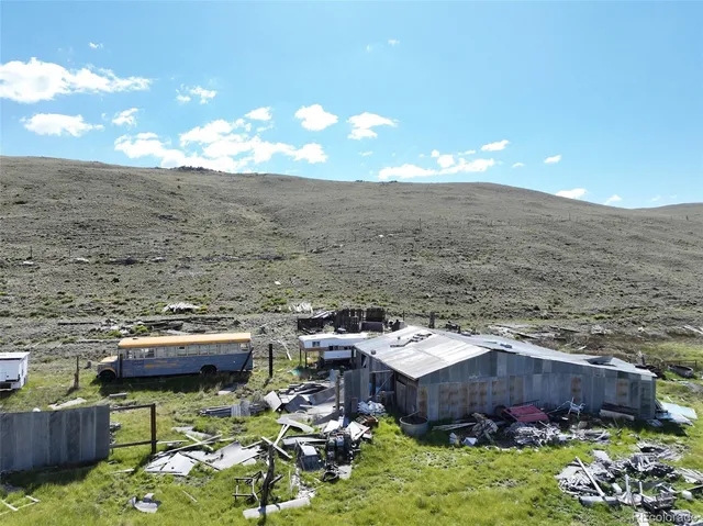 a view of a terrace with lawn chairs