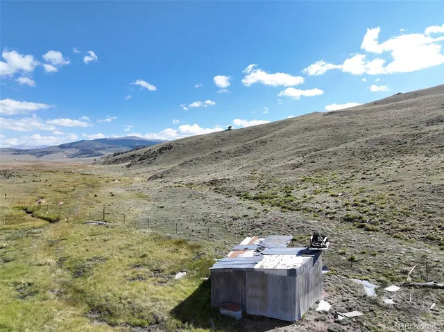a view of a large building with mountains in the background