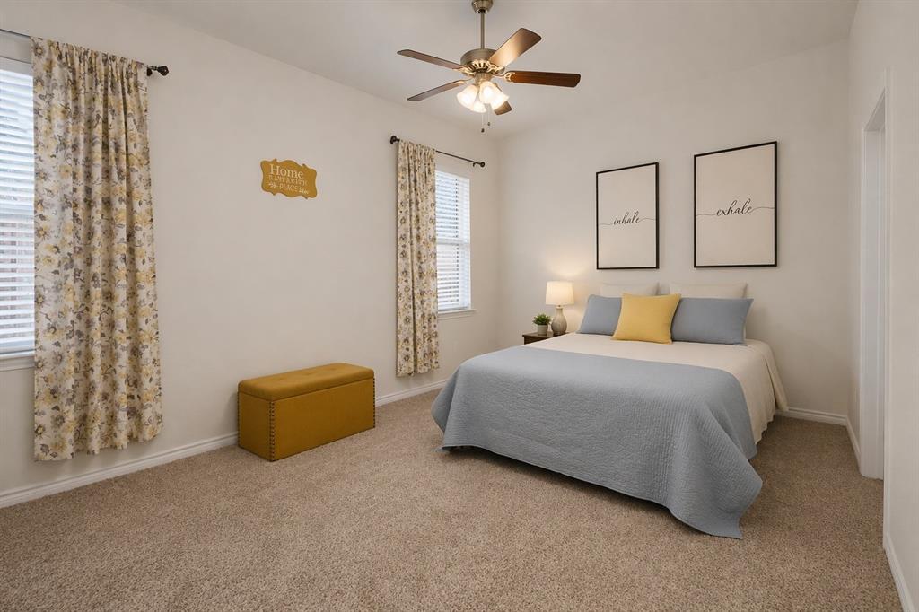 3106 Maverick Drive Forney, TX 75126 - Photo 9 of 32 a bedroom with a bed and a chandelier