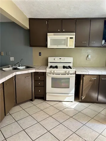 a kitchen with a stove top oven sink and cabinets